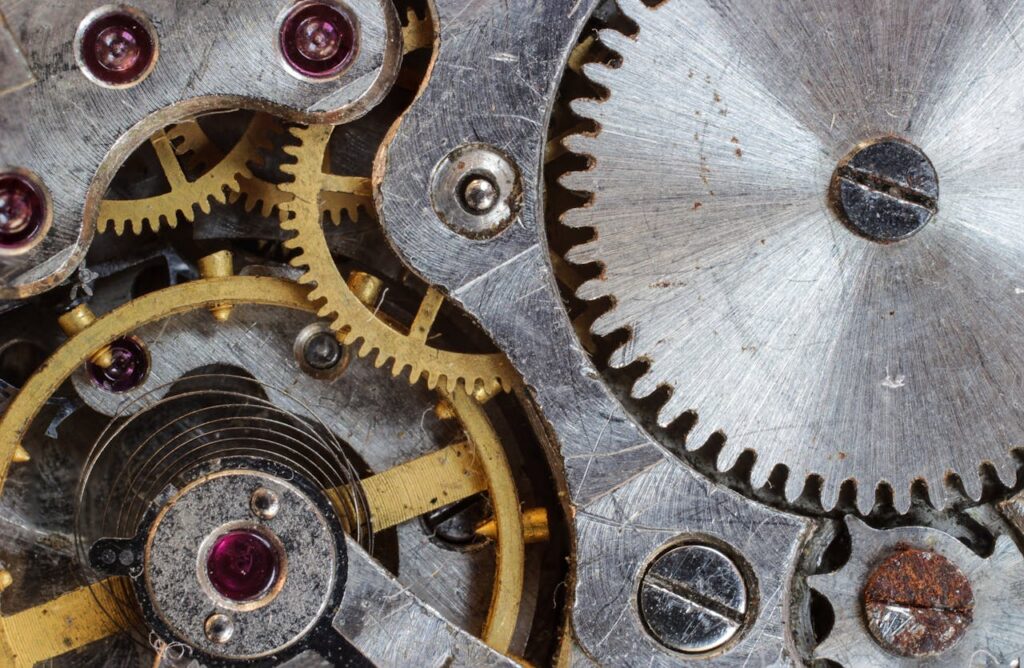 Detailed close-up of interlocking gears and cogs in a complex mechanical system.
